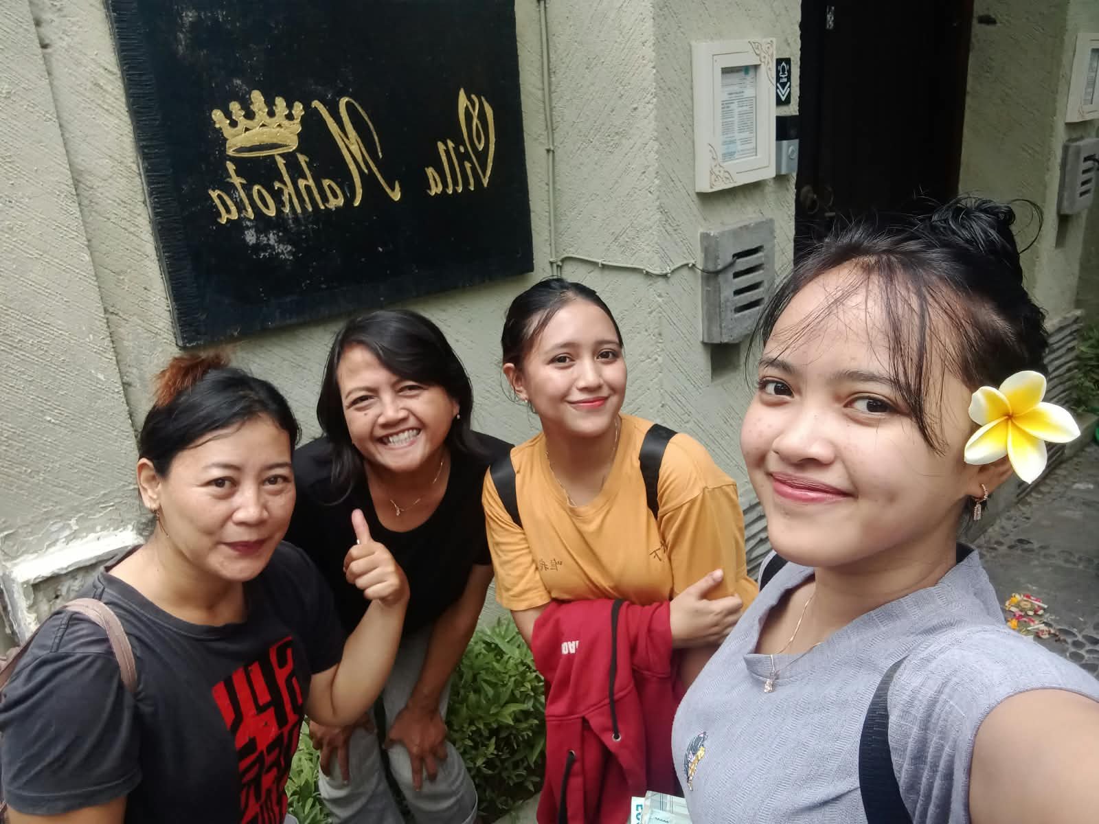 Massage team together outside a villa