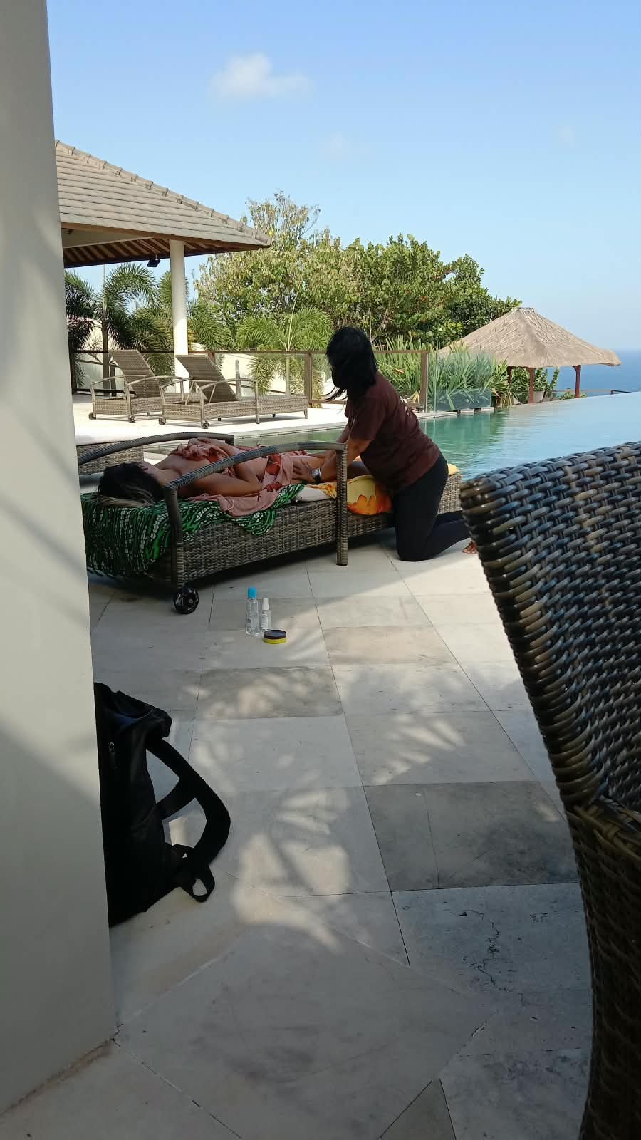 Massage session beside a villa pool